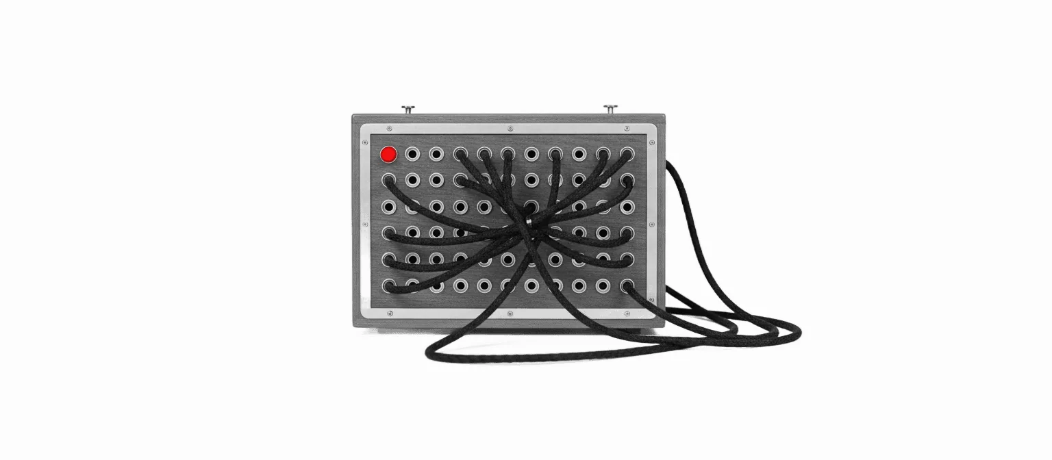 A black-and-white vintage telephone switchboard with rows of patch-cable jacks and one braided cable in vivid red — the routing-hub metaphor for the Claude Cowork cluster.